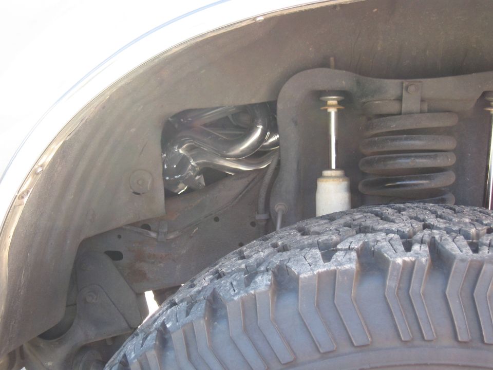 Chrome Bassani headers visible in wheel well