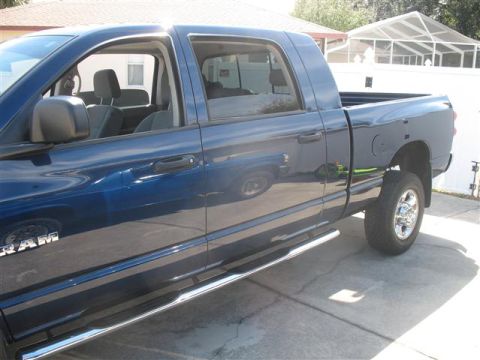 2008 Dodge 1500 - A blue pickup truck is shown from the side, with chrome step bars and 'RAM' badging visible on the lower body.