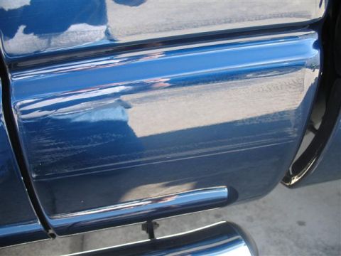 2008 Dodge 1500 - Scratches are visible on the side of the blue 2008 Dodge 1500 truck.