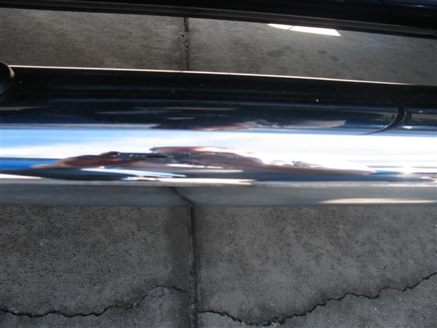 Chrome step bar on a vehicle showing rust and damage