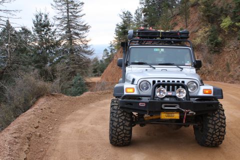 2003 Jeep TJ - Silver 2003 Jeep TJ equipped for off-roading on a mountain trail.