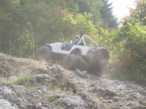 1979 Ford Bronco - Off-road vehicle navigating challenging rocky terrain on a sunny day.