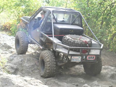 1979 Ford Bronco - This heavily modified off-road vehicle navigates a challenging rocky trail.