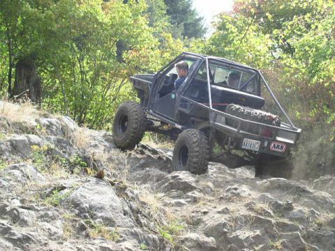 1979 Ford Bronco - A modified off-road vehicle navigates a challenging rocky trail.