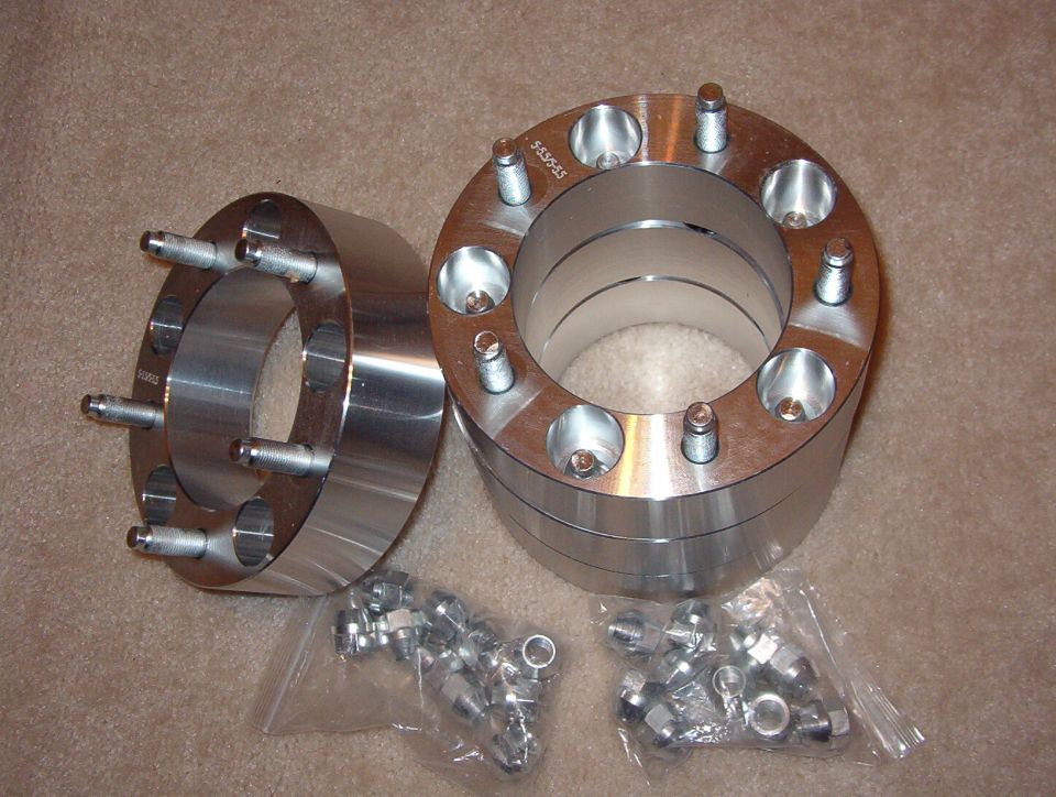 Polished aluminum wheel spacer adapters with studs and lug nuts