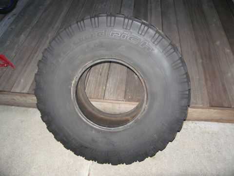 1986 Ford Bronco - A BFGoodrich All-Terrain T/A tire is shown resting on wooden planks.