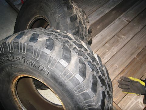 1986 Ford Bronco - A close-up view of two BFGoodrich Mud-Terrain T/A tires with aggressive tread patterns.