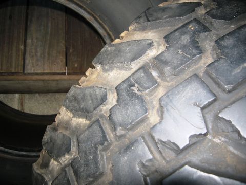 1986 Ford Bronco - A close-up view of a tire tread, showing its aggressive pattern and accumulated dirt.