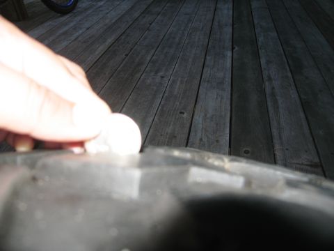 1986 Ford Bronco - Tire tread depth check using a coin.