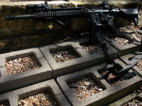 1996 Ford Bronco - A rifle is placed on concrete blocks and stone, with a watermark indicating SuperMotors.net.