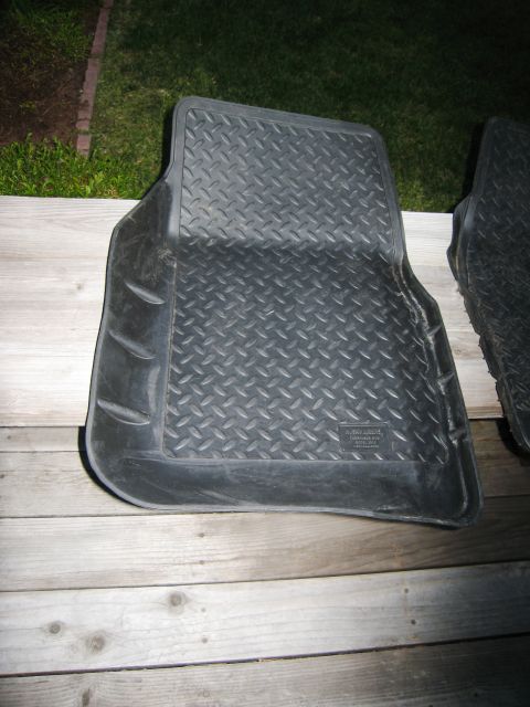 1986 Ford Bronco - A black rubber floor mat with a diamond tread pattern is shown, likely for a vehicle's interior.