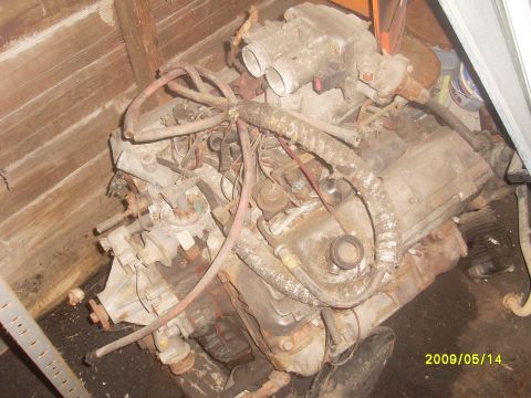 1996 Ford F-150 - Engine assembly in a cluttered space, with visible hoses and wiring. Date stamp indicates 2009.