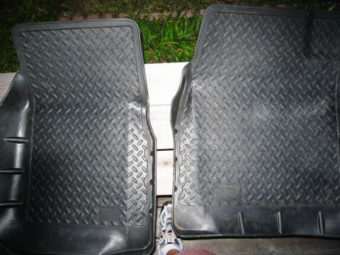 1986 Ford Bronco - Pair of black rubber floor mats with diamond tread pattern are shown laid out on a wooden surface.