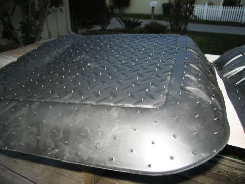 1986 Ford Bronco - A close-up of a rubber floor mat with a textured surface and numerous small spikes.