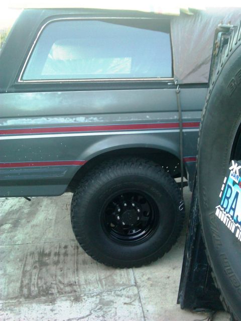 1986 Ford Bronco - Side view of a 1986 Ford Bronco showing its body lines and wheel.