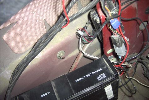 1997 Ford Taurus - A close-up view of a car's interior reveals a compact disc changer and various electrical wires.