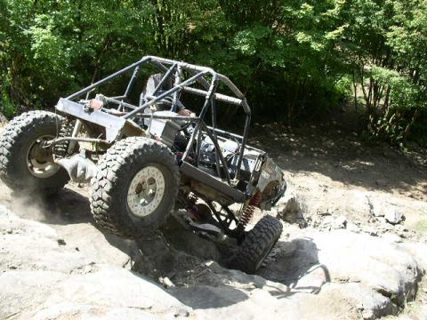 1979 Ford Bronco - A custom-built off-road buggy navigates a challenging rocky terrain.