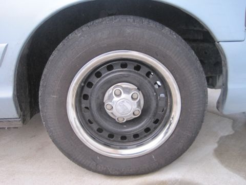 1999 Ford Crown Victoria - Close-up of a vehicle's wheel and tire assembly, showing the rim and tire tread.