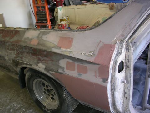 1972 Ford Ranchero - The rear quarter panel of a 1972 Ford Ranchero is undergoing bodywork, showing primer and filler.