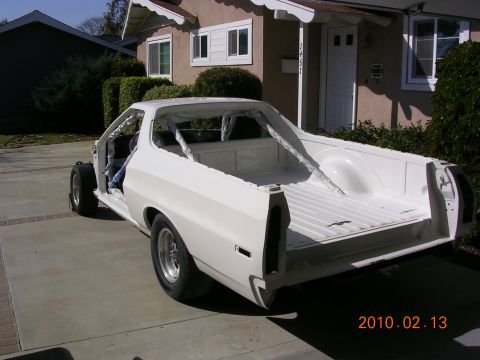 1972 Ford Ranchero - A white 1972 Ford Ranchero pickup truck is parked in a driveway, appearing to be in the process of restoration.