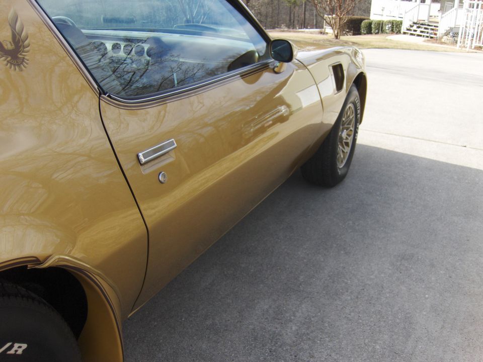 Gold Pontiac Trans Am door and quarter panel with gold snowflake wheels