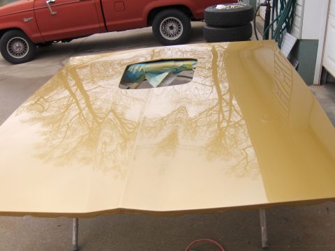 1978 Pontiac Trans Am - A red truck is seen from the side, positioned above a wooden ramp.