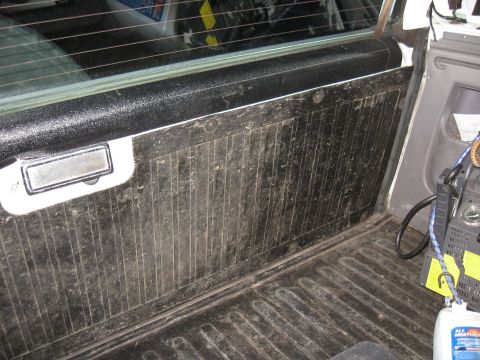 1994 Ford Bronco - Interior view of a vehicle's door panel, showing the handle and window frame.