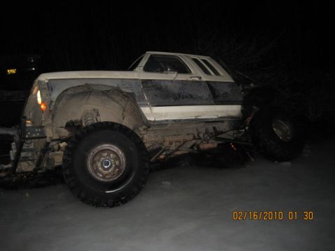 1990 Ford F-250 - This 1990 Ford F-250 pickup truck is seen from a 3/4 front angle in a dimly lit area.