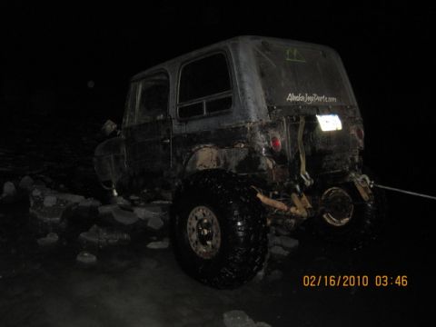 1990 Ford F-250 - A damaged van sits in the dark, its front end heavily compromised.