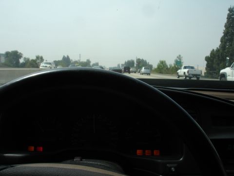 1993 Ford Taurus - Driving on a hazy highway with multiple vehicles visible in the distance.