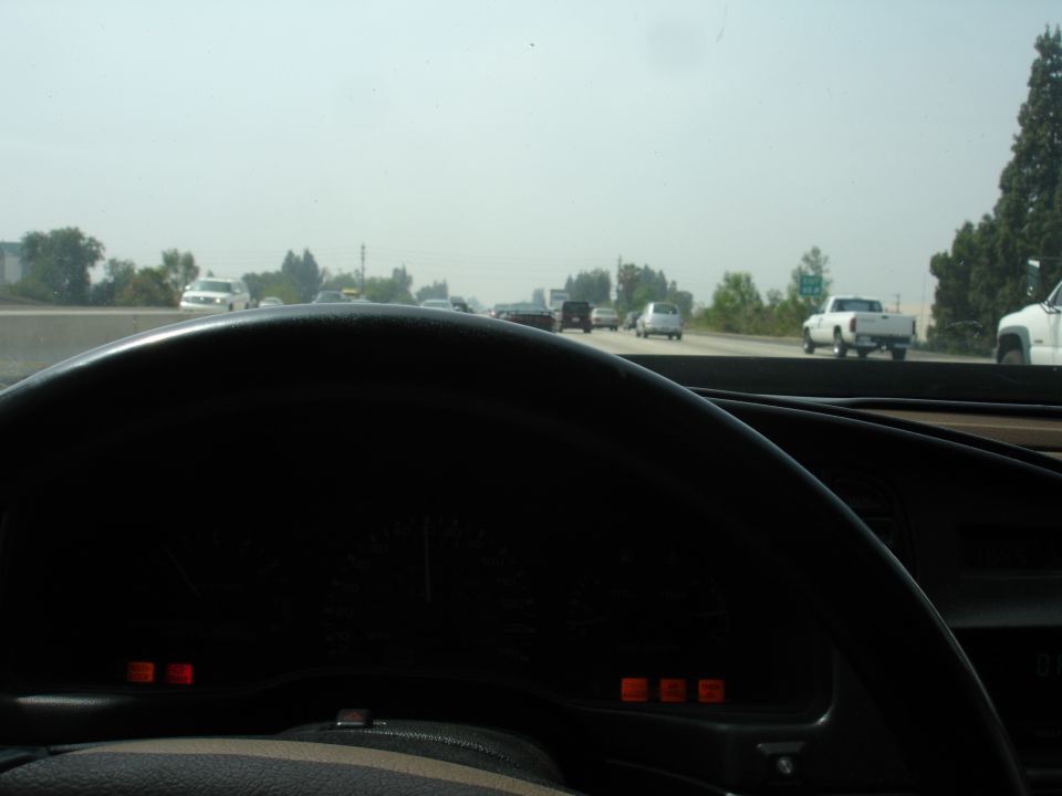 View from driver's seat looking at dashboard and highway traffic ahead