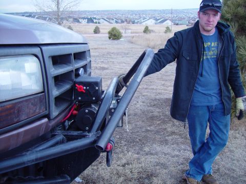 1993 Ford Bronco - A man stands next to the front of a brown 1992 Ford Bronco, which has a custom bumper and winch installed.
