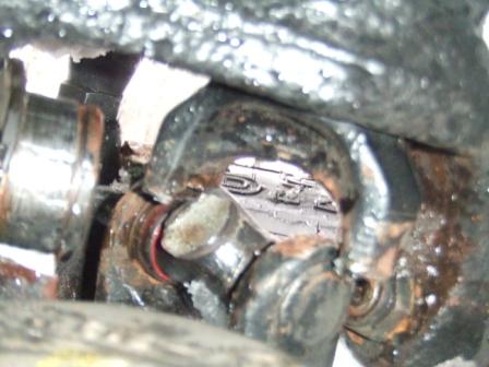 1996 Ford Bronco - A close-up view of a worn driveshaft universal joint, with the Supermotors.net logo visible in the background.