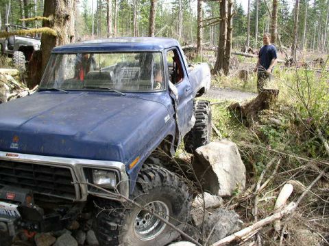 1979 Ford Bronco - 1979 Ford Bronco navigating rough terrain with a second vehicle in the background.