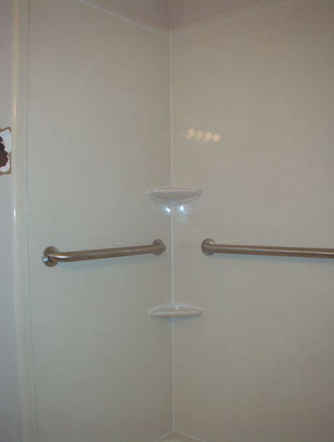 2004 Land Rover Land Rover - Interior of a shower stall with grab bars and a soap dish. Watermark visible.