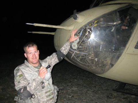 2003 Jeep TJ - A soldier stands by a military helicopter at night, highlighting its exposed internal components.