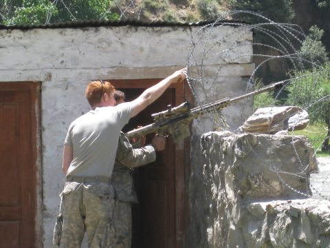 2003 Jeep Wrangler - Two soldiers are positioned near a stone structure, one aiming a sniper rifle over a barbed wire fence.