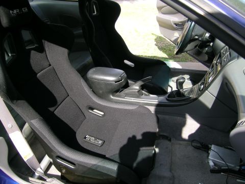 1995 Ford Probe - Custom racing seats installed in a vehicle's interior, showing the center console and gear shifter.
