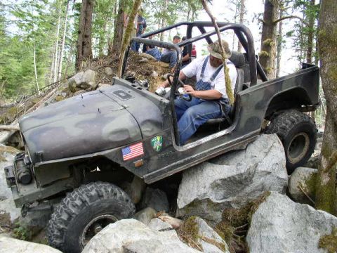 1979 Ford Bronco - A driver navigates a challenging rocky terrain in a modified off-road vehicle.