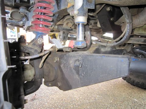 1996 Ford Bronco - Close-up view of the complex suspension system and axle of an off-road vehicle.