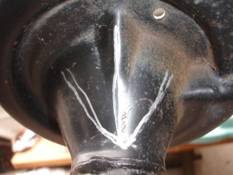 1995 Ford Taurus - Close-up of a black suspension component marked with white lines, possibly for alignment or identification.