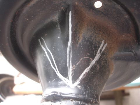 1995 Ford Taurus - Close-up of a metal automotive part with chalk markings, likely for installation reference.