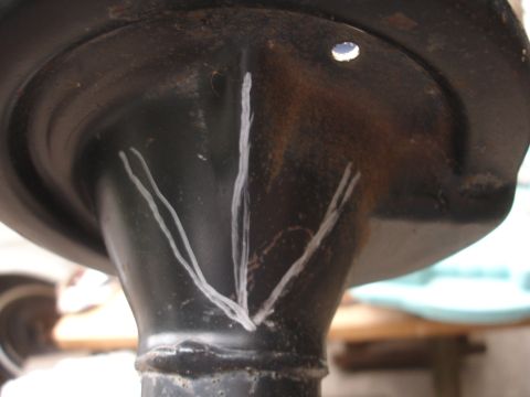 1995 Ford Taurus - A close-up view of a suspension component, marked with white chalk lines for reference.