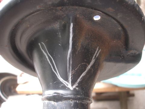 1995 Ford Taurus - A close-up view of a worn suspension component with chalk markings.