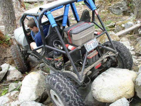 1979 Ford Bronco - Buggy navigating difficult rocky terrain. License plate 874-GBA is visible on the rear.