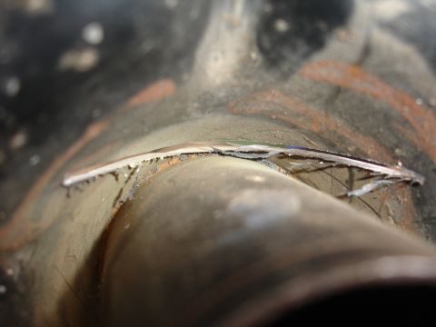 1995 Ford Taurus - Cracked metal pipe showing damage and wear.