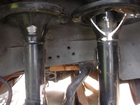 1995 Ford Taurus - Close-up view of automotive suspension parts, showing wear and rust.