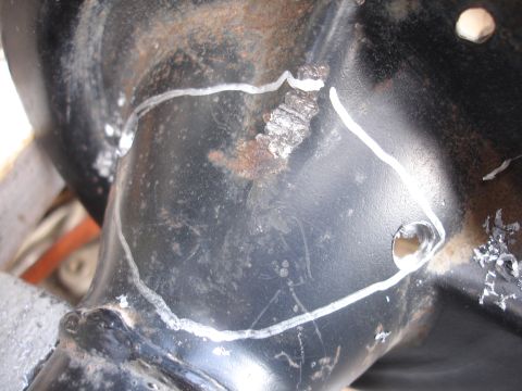 1995 Ford Taurus - This is a close-up view of a vehicle's suspension component, marked with white lines and showing signs of rust.