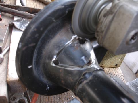 1995 Ford Taurus - A close-up shows a metal component being worked on with a grinding tool.