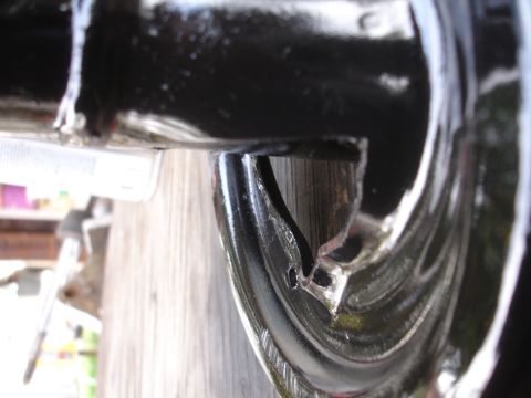 1995 Ford Taurus - A detailed view of a black automotive suspension component, showing its shape and mounting points.